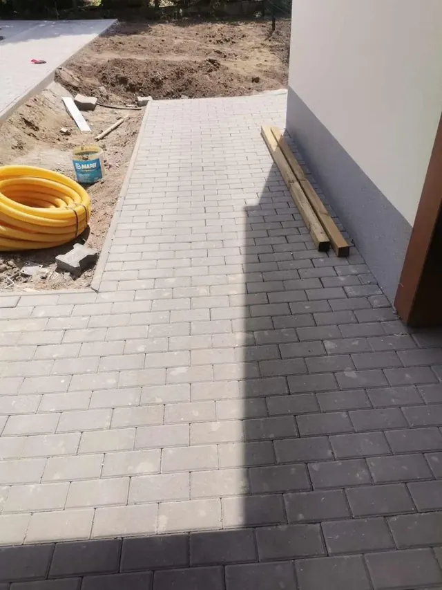 Téglakő burkolat a ház bejáratánál, szegéllyel csatlakoztatva a kerti úthoz
